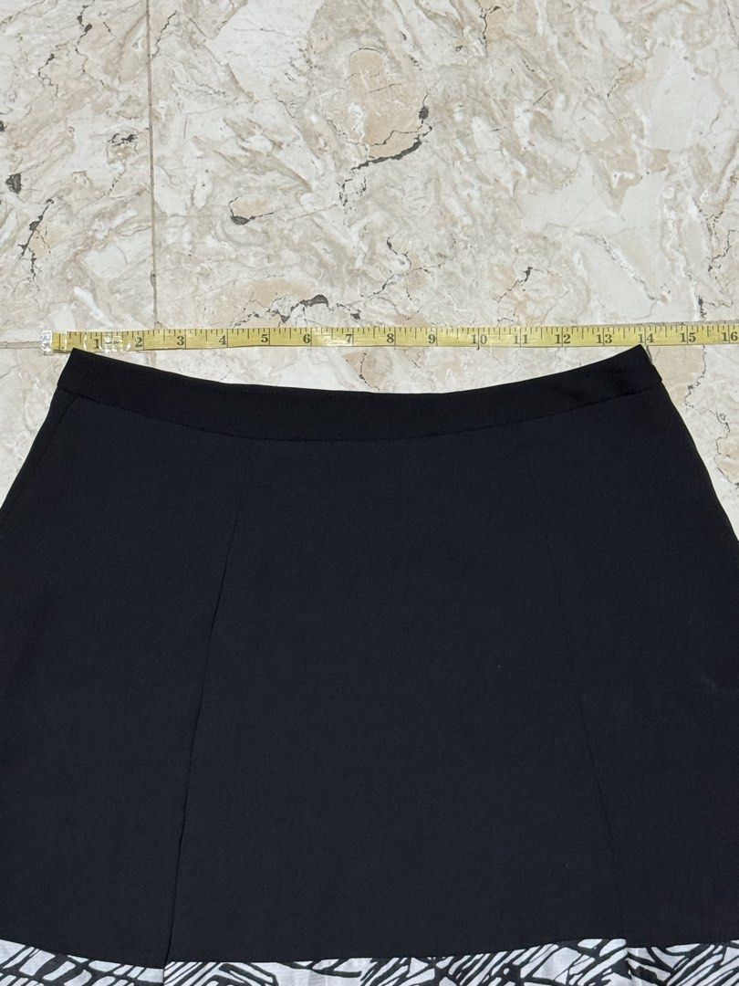 Black A-line Skirt with Geometric Hem (Category: Skirts) located in Quezon City. Submitted by EveryWANTShop (Listing ID 1454887221, Image 2). Description: - Stylish black A-line skirt - Features a cool geometric pattern at the hem - Flared design for a flattering silhouette - Versatile piece, easy to dress up or down and pair with various tops.