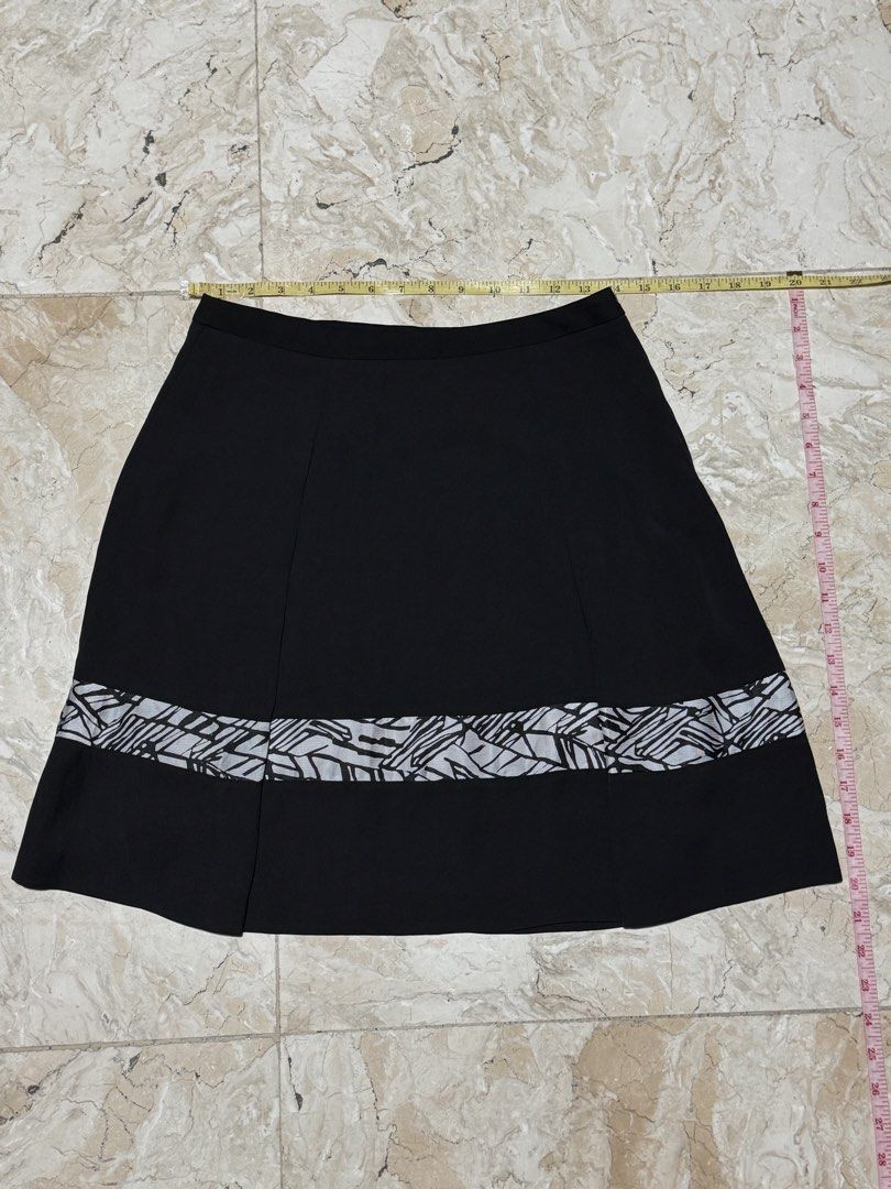 Black A-line Skirt with Geometric Hem (Category: Skirts) located in Quezon City. Submitted by EveryWANTShop (Listing ID 1454887221, Image 1). Description: - Stylish black A-line skirt - Features a cool geometric pattern at the hem - Flared design for a flattering silhouette - Versatile piece, easy to dress up or down and pair with various tops.