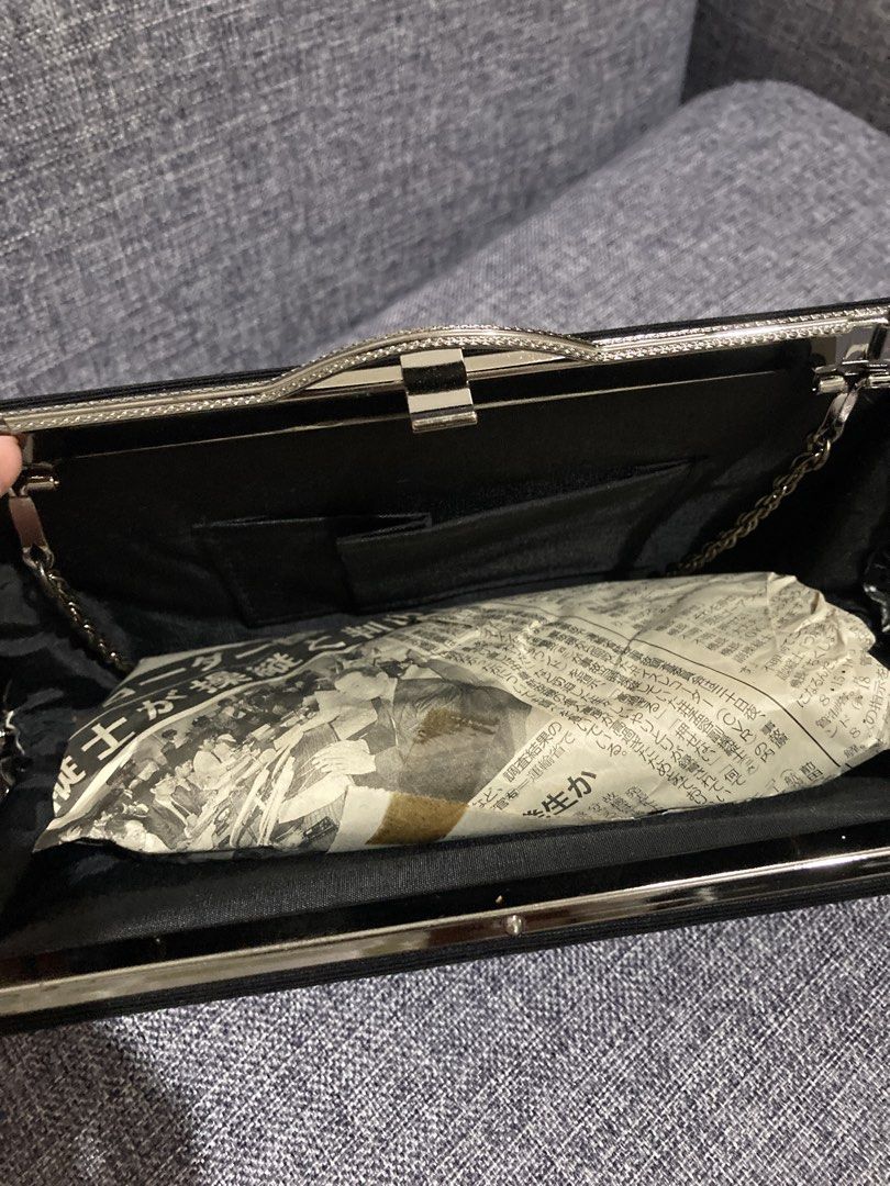 Black Fabric Clutch Bag with Silver Clasp (Category: Clutches) located in Valenzuela. Submitted by theaveqc04360 (Listing ID 1454905055, Image 3). Description: - Classic black clutch bag - Textured weave fabric exterior - Secure silver metal clasp closure - Interior includes a small chain strap - Built-in card slots for essentials - Perfect for evenings out or special occasions - Approximate dimensions: 9 inches wide, 4 inches tall.
