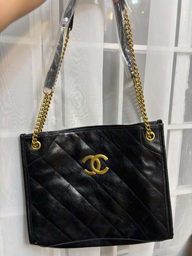 Black Quilted Handbag with Gold Chain Strap (Category: Luxury Bags & Wallets) located in Las Pinas. Submitted by aguilar_andrea (Listing ID 1454864920, Image 1). Description: - Black quilted handbag - Shiny finish - Gold CC logo accent - Gold chain strap - Spacious interior - Versatile for everyday or evening wear.