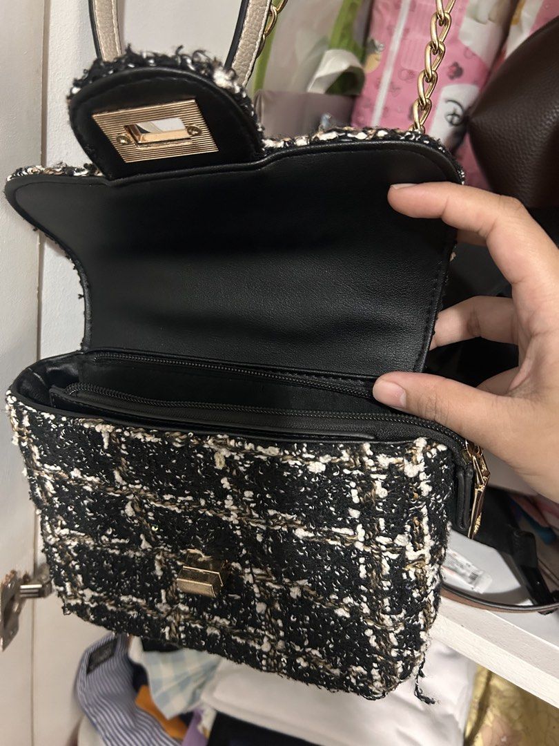 Black Tweed Chain Shoulder Bag with Gold strap (Category: Luxury Bags & Wallets) located in Manila. Submitted by n1khola1_20051606 (Listing ID 1454774624, Image 3). Description: - Cute black tweed shoulder bag - Classic checkered pattern with white and gold threads - Gold chain strap - Gold clasp closure - Interior zippered compartment - Ideal for nights out or adding flair to everyday outfits RFS: Declutter 🚚 sf/df shouldered by the buyer STILL