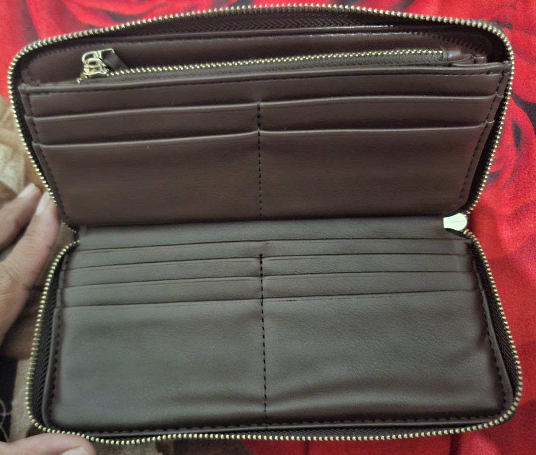 Brown Leather Zip Around Wallet with Gold Logo (Category: Wallets & Card holders) located in Muntinlupa City. Submitted by abunching (Listing ID 1454908312, Image 2). Description: - Rich brown leather wallet - Elegant gold zipper closure - Prominent gold logo on the front - Ample card slots for all your cards - Multiple compartments for bills and essentials - Includes a small zippered pocket for coins or small items - Perfect for keeping your cas