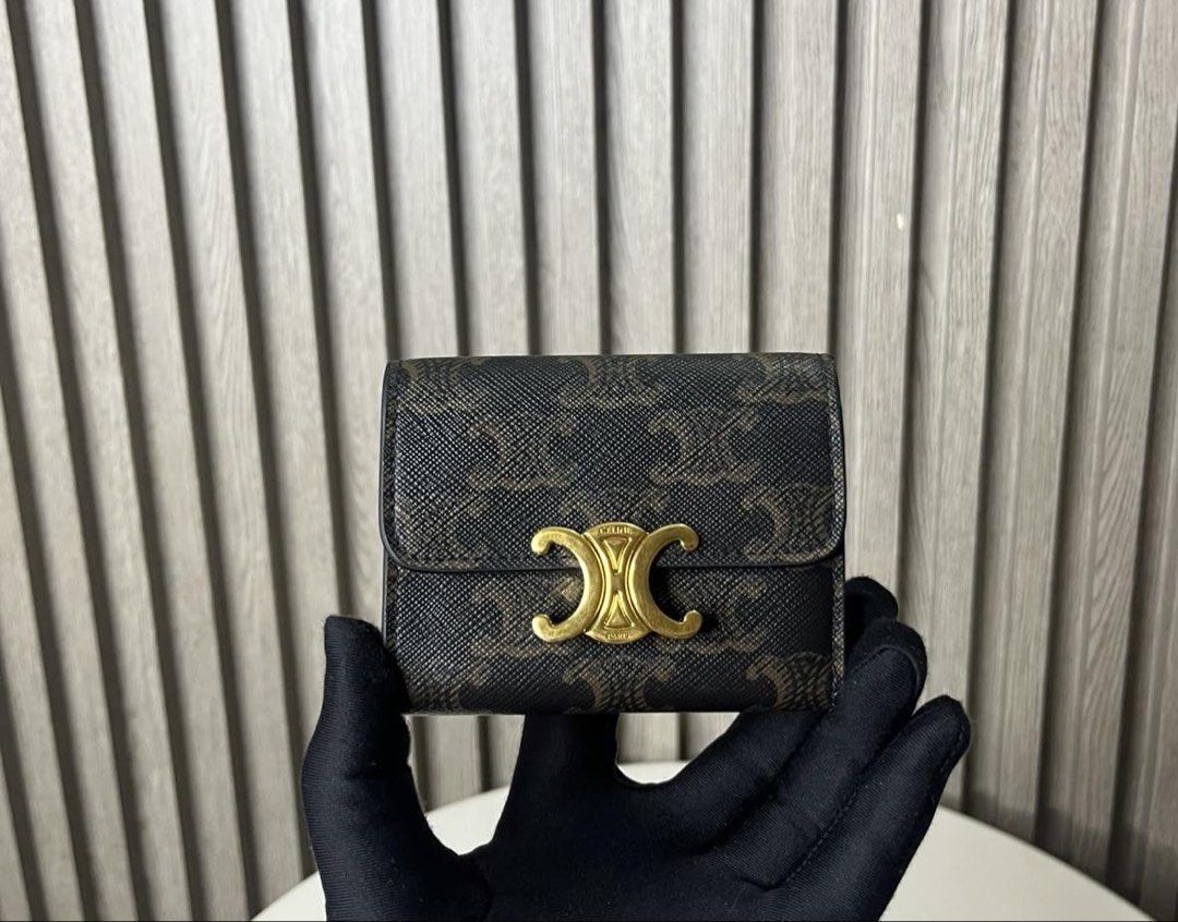 Celine Triomphe Canvas Small Wallet (Category: Luxury Bags & Wallets) located in Taguig. Submitted by almero22 (Listing ID 1454910886, Image 1). Description: - Authentic Celine small wallet - Iconic Triomphe canvas with Triomphe logo hardware - Practical design with a zip pocket and card slots - Elegant brown and black colorway.