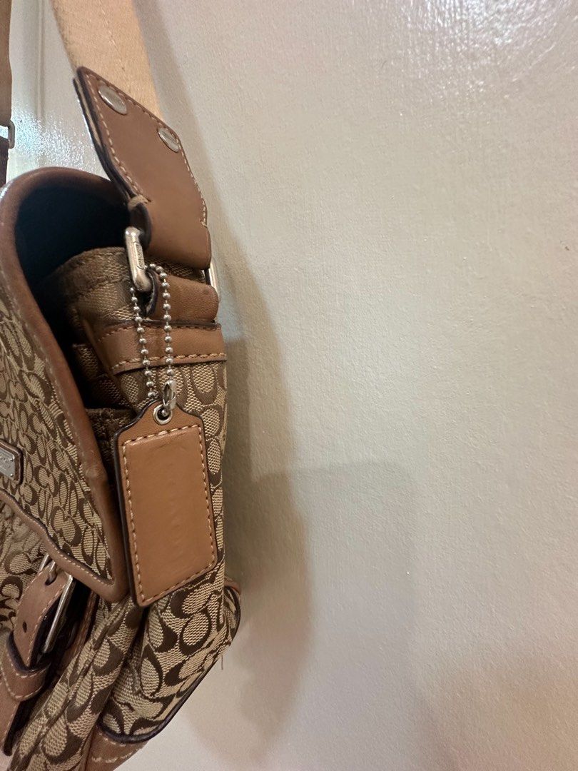 Coach Monogram Canvas Leather Trim Shoulder Bag (Category: Luxury Bags & Wallets) located in Manila. Submitted by TindahanNiLhelay (Listing ID 1454753244, Image 3). Description: - Classic Coach monogram shoulder bag - Color: Brown and tan canvas with leather trim - Features buckle closures on the front flap - Spacious interior with a zippered pocket - Adjustable strap for comfortable wear - Ideal for everyday use .