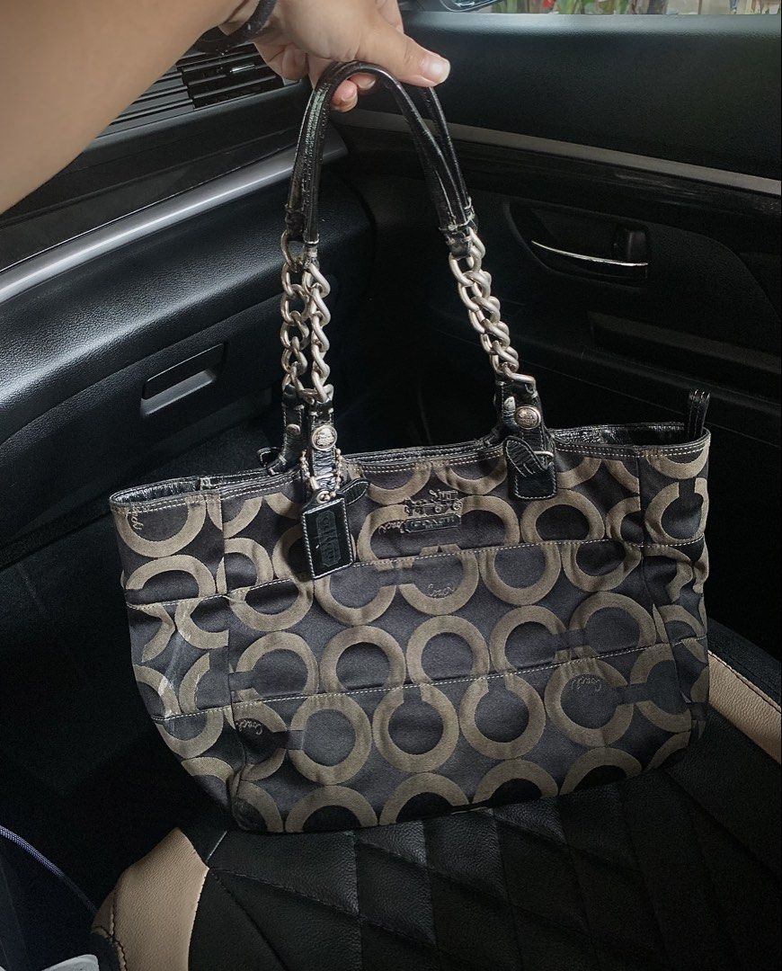Coach Signature C Monogram Tote Bag with Chain Straps (Category: Luxury Bags & Wallets) located in Manila. Submitted by obenarioan15240 (Listing ID 1454792201, Image 1). Description: - Classic Coach tote bag - Signature brown and tan C monogram pattern - Shiny black patent leather handles - Silver chain accents - Spacious interior for essentials - Ideal for everyday use or weekend getaways - Stylish and practical addition to your collection Issue