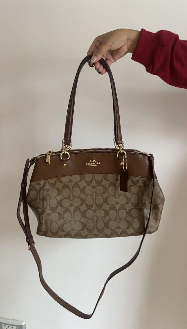 Coach Signature Monogram Brown Leather Shoulder Bag (Category: Luxury Bags & Wallets) located in Bulacan. Submitted by bella.ken.varietystore (Listing ID 1454868021, Image 1). Description: Classic Coach monogram shoulder bag. Brown signature canvas with leather trim. Gold hardware details. Top zip closure. Has a detachable crossbody strap. Plenty of space inside for your essentials. Great everyday bag..