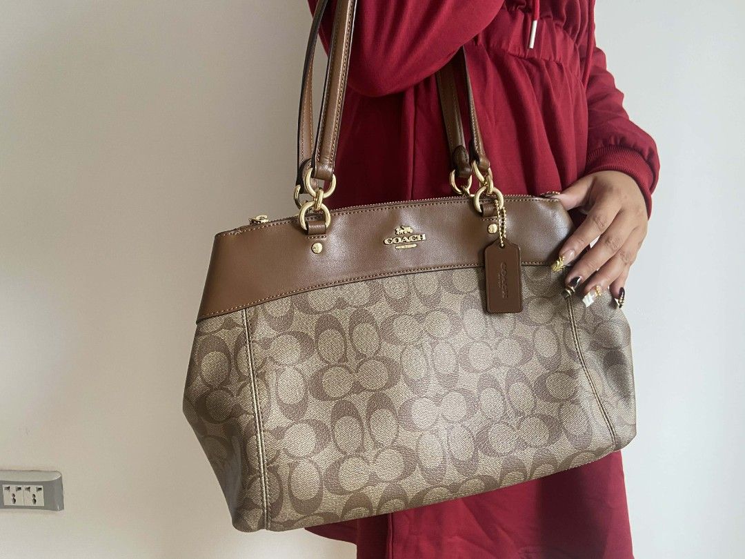 Coach Signature Monogram Brown Leather Shoulder Bag (Category: Luxury Bags & Wallets) located in Bulacan. Submitted by bella.ken.varietystore (Listing ID 1454868021, Image 3). Description: Classic Coach monogram shoulder bag. Brown signature canvas with leather trim. Gold hardware details. Top zip closure. Has a detachable crossbody strap. Plenty of space inside for your essentials. Great everyday bag..