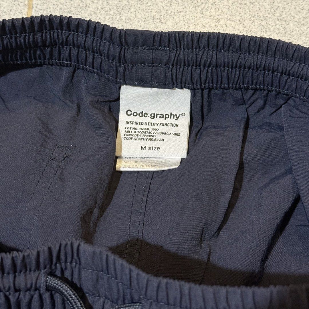 Codegraphy Nylon Shorts (Category: Shorts) located in Singapore. Submitted by friendlyneighbor_k (Listing ID 1454874270, Image 3). Description: * Lightweight and comfortable for everyday wear * Durable nylon material * Water-repellent / splash-resistant fabric * Quick-drying and easy to care for * Relaxed fit with a practical, comfortable length * Great for casual wear, travel, outdoor activities, or daily use * Simple, versatile design that’s ea