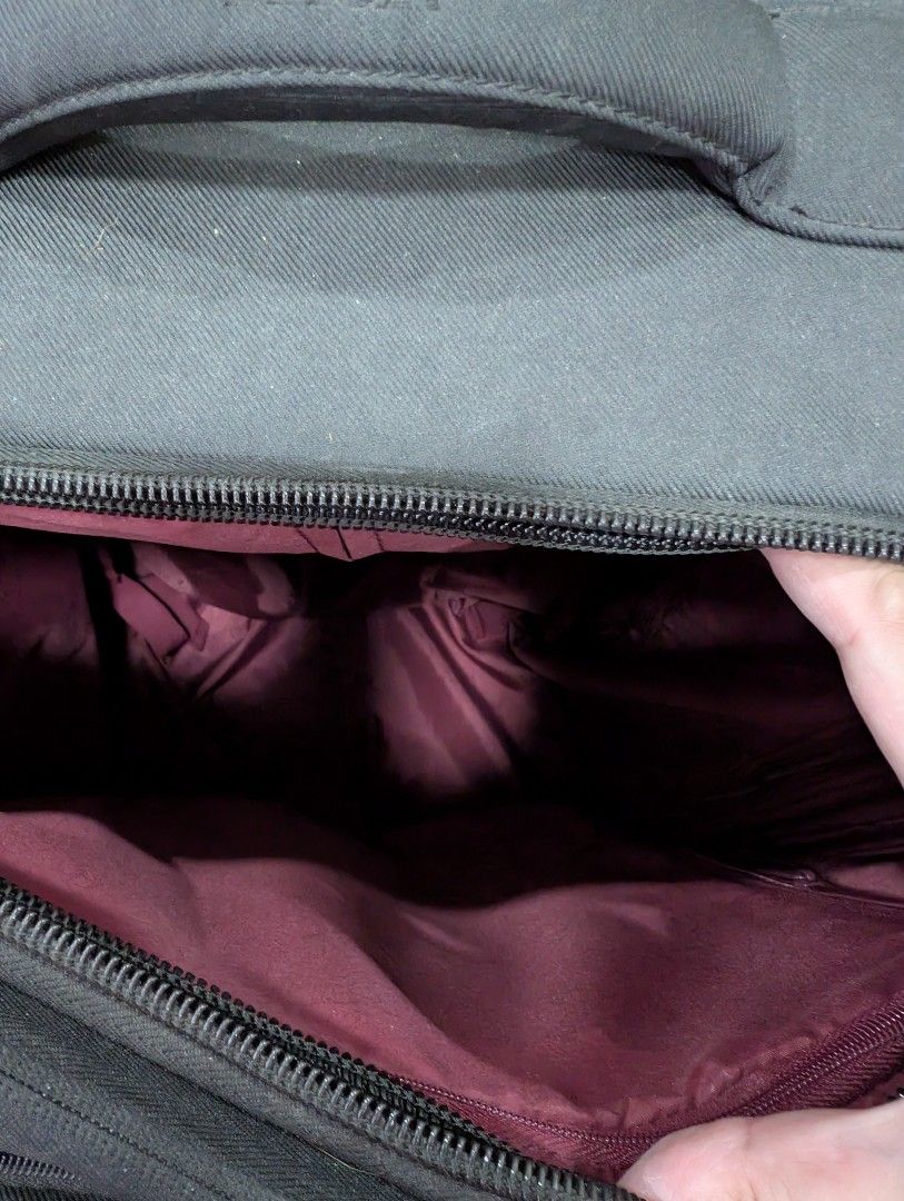 Delsey Collection Black Softside Spinner Luggage (Category: Luggage) located in Silang. Submitted by akalcol (Listing ID 1454842311, Image 3). Description: - Brand: Delsey - Color: Black - Exterior Features: Front zippered pocket - Interior Features: Burgundy fabric lining - Mobility: Four spinner wheels for 360° maneuverability - Handle: Extendable - Condition: Used, with some signs of wear on exterior and wheels .