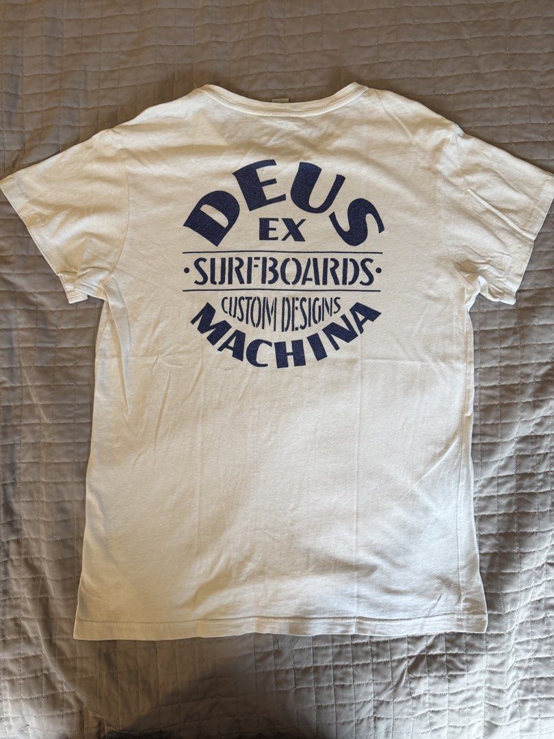 Deus Ex Machina Surfboards White Tshirt (Category: Tshirts & Polo Shirts ) located in Quezon City. Submitted by harringtonmnl (Listing ID 1454862635, Image 1). Description: Deus Ex Machina Surfboards Tshirt White color with Blue text Dimes 21 x 29 Large size For Surfers and Bikers.