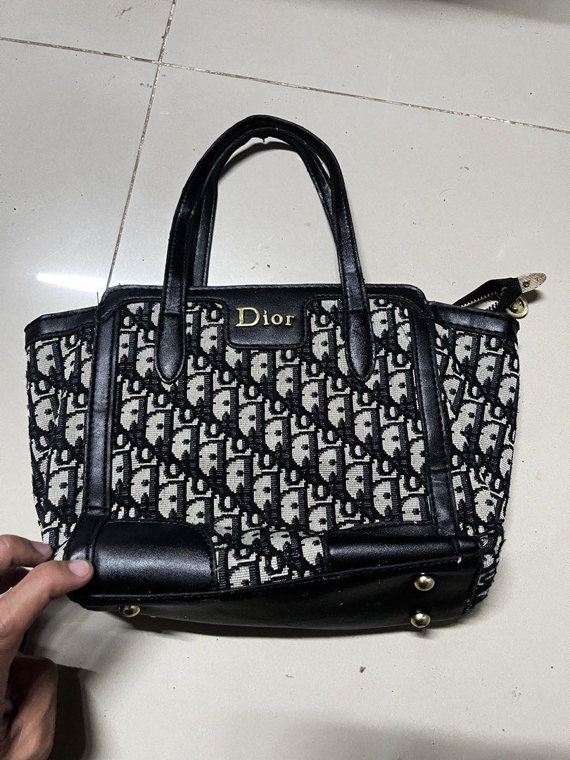 Dior Monogram Canvas Leather Tote Bag (Category: Luxury Bags & Wallets) located in Manila. Submitted by jj_thrift (Listing ID 1454828473, Image 1). Description: - Classic Dior tote bag - Iconic Dior monogram canvas - Black leather trim - Top handles - Zip closure - Interior leather patch with Dior logo - Serial number: SP2175 - Ideal for everyday use.