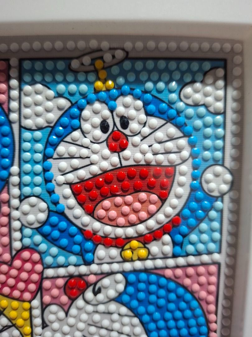 Doraemon Diamond Painting Framed Art (Category: Art & Prints) located in Tagaytay City. Submitted by maestraklarissa (Listing ID 1454889751, Image 2). Description: - Adorable Doraemon diamond painting - Features four panels with Doraemon in different poses - Comes in a stylish white frame - Perfect gift for any Doraemon enthusiast - Adds a vibrant splash of color to your space - Ready to hang upon arrival.
