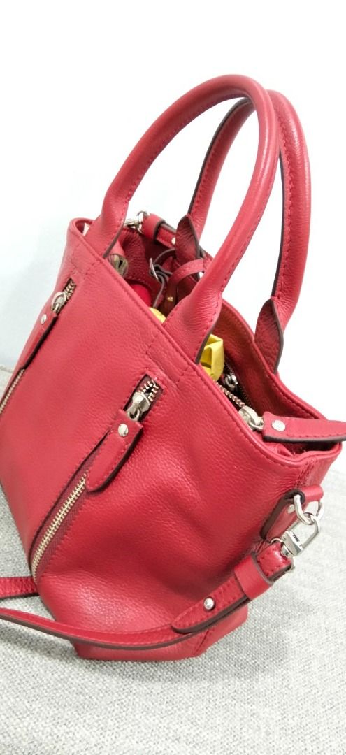 FINO Leatherware Red Pebble Grain Leather Handbag (Category: Luxury Bags & Wallets) located in Makati City. Submitted by pre_loved_items_.moon (Listing ID 1454816144, Image 1). Description: - Genuine red leather handbag from FINO Leatherware - Elegant pebble grain texture - Comfortable top handles - Includes a detachable crossbody strap for versatility - Two convenient zippered pockets on the front - Interior lined with red fabric - Ample space f
