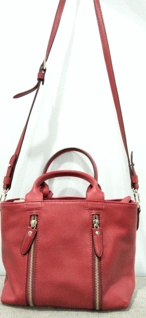 FINO Leatherware Red Pebble Grain Leather Handbag (Category: Luxury Bags & Wallets) located in Makati City. Submitted by pre_loved_items_.moon (Listing ID 1454816144, Image 2). Description: - Genuine red leather handbag from FINO Leatherware - Elegant pebble grain texture - Comfortable top handles - Includes a detachable crossbody strap for versatility - Two convenient zippered pockets on the front - Interior lined with red fabric - Ample space f