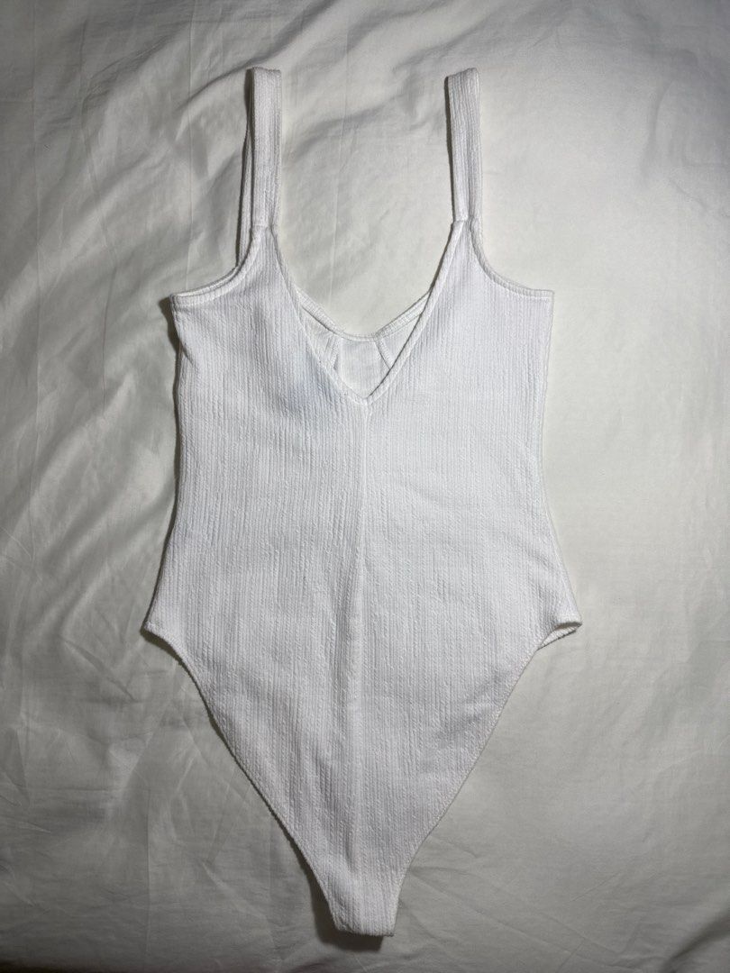 Forever 21 White Ribbed Hook and Eye Bodysuit - Size M (Category: Others Tops) located in Quezon City. Submitted by minispirea (Listing ID 1454848622, Image 2). Description: Brand new / never used but no more tag • On hand & ready to ship • More photos/videos available upon request • Pay as you order • No returns or exchanges Location: Quezon City / BGC Delivery: • Weekdays — same-day evening or next-day delivery due to work • Weekends — anytime 