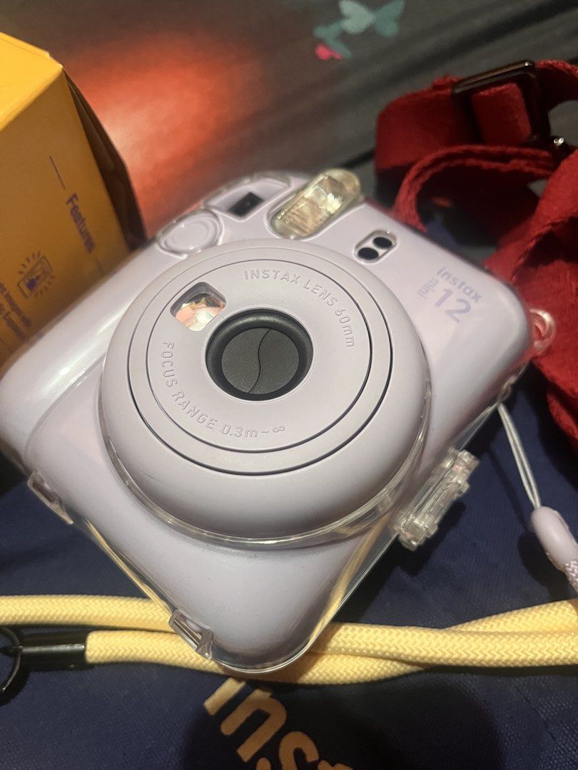 Fujifilm Instax Mini 12 Lilac Purple Camera Bundle (Category: Cameras) located in Manila. Submitted by drzy_28 (Listing ID 1454782926, Image 2). Description: Bought it brand new at original price last May and only used it at home so it comes w film pa since pang test shot lang ‘yung mga nabawas. Selling because | don’t use it anymore. Condition: Very well-kept Inclusions: - Fujifilm Instax Mini 12 Camera in Lilac Purple - Includes a clear protect
