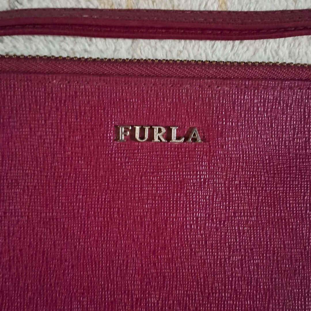 Furla Leather Pouch (Category: Luxury Bags & Wallets) located in Pila. Submitted by ester_aurea (Listing ID 1454860574, Image 2). Description: Preloved Gcash payment plus sf No cod - Authentic Furla pouch - Made in Tunisia - 7x9 inches - Deep berry textured leather - Detachable wrist strap - Zipper closure - Ideal for organizing essentials or as a standalone clutch.