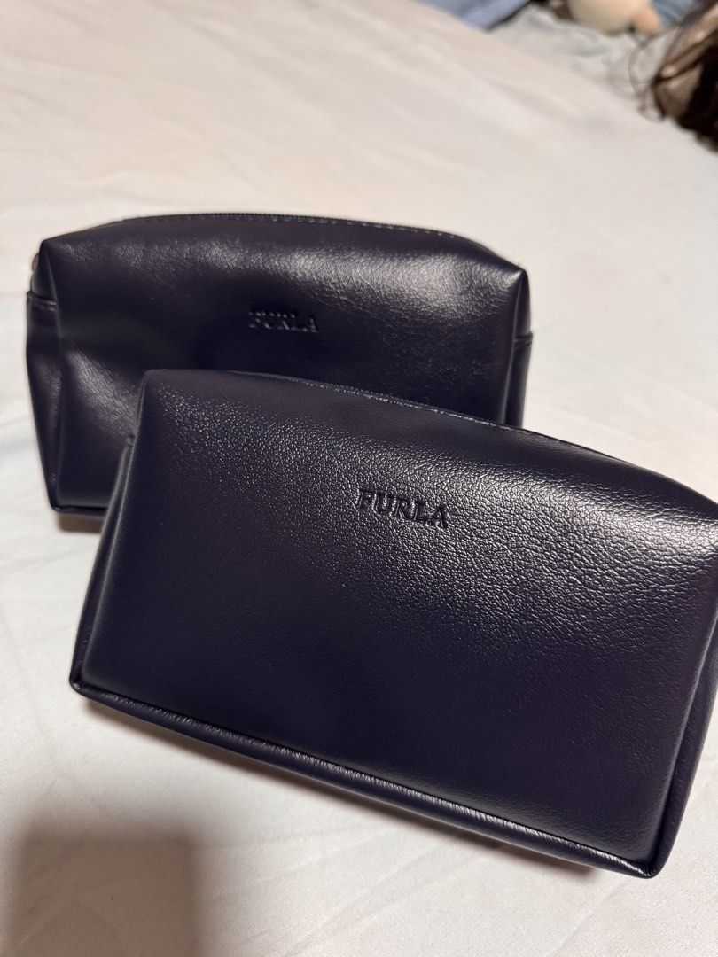 Furla x PAL pouch only (Category: Purses & Pouches) located in Marikina City. Submitted by 1stuffshop (Listing ID 1454871493, Image 1). Description: - Authentic Furla x Philippine Airlines collaboration pouch - Elegant navy blue color - High-quality material with subtle Furla branding - Unique Philippine Airlines patterned interior lining - Perfect for makeup, travel, or daily organization.