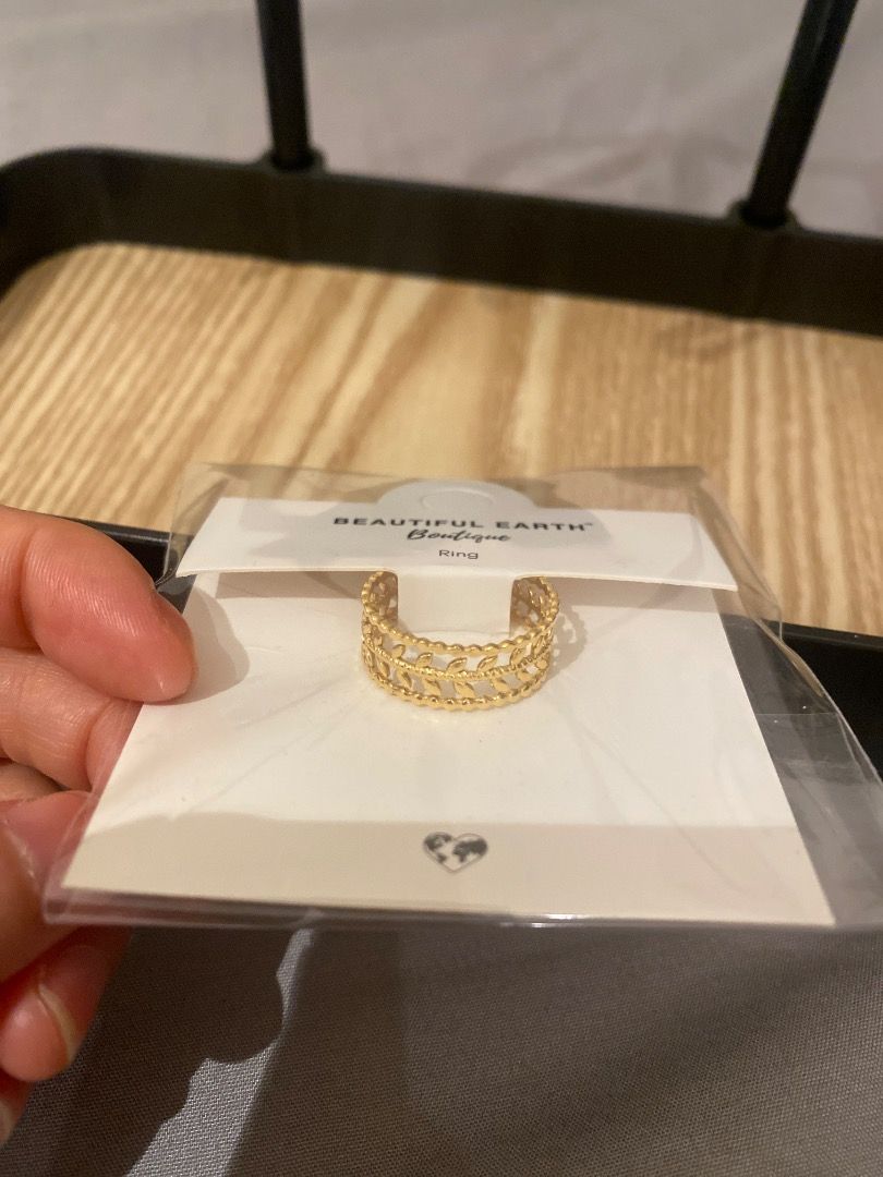 Gold Leaf Pattern Ring (Category: Rings) located in Singapore. Submitted by sellingpreloved_carousel (Listing ID 1454905097, Image 2). Description: - Delicate gold ring - Features a repeating leaf pattern - Band has small beaded details along edges - Unique and intricate design - Ideal for stacking or wearing alone.