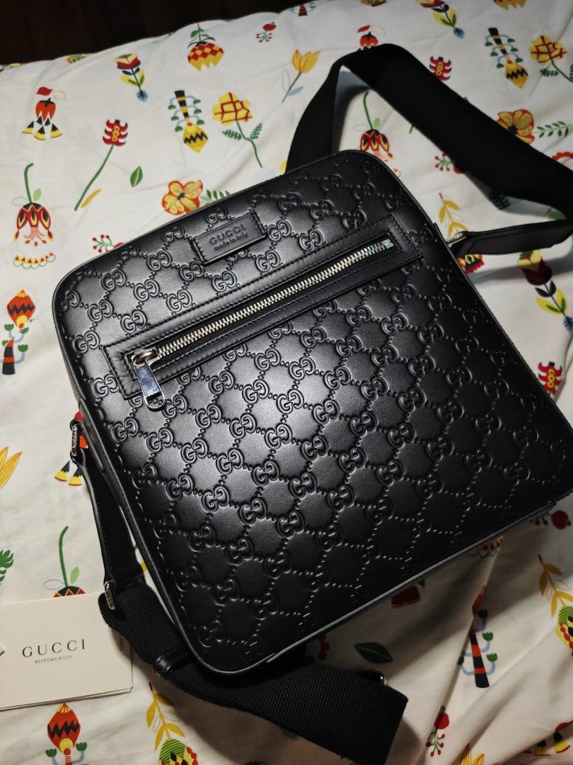 Gucci Black Leather GG Embossed Messenger Bag (Category: Luxury Bags & Wallets) located in Quezon City. Submitted by mike525 (Listing ID 1454933159, Image 1). Description: - Authentic black leather Gucci messenger bag - All-over GG embossed pattern - Zip closure on top - Front zip pocket - Interior small pouch Features a rectangular messenger silhouette with an adjustable strap for crossbody wear. - With Silver tone Hardware - Comes with authenti