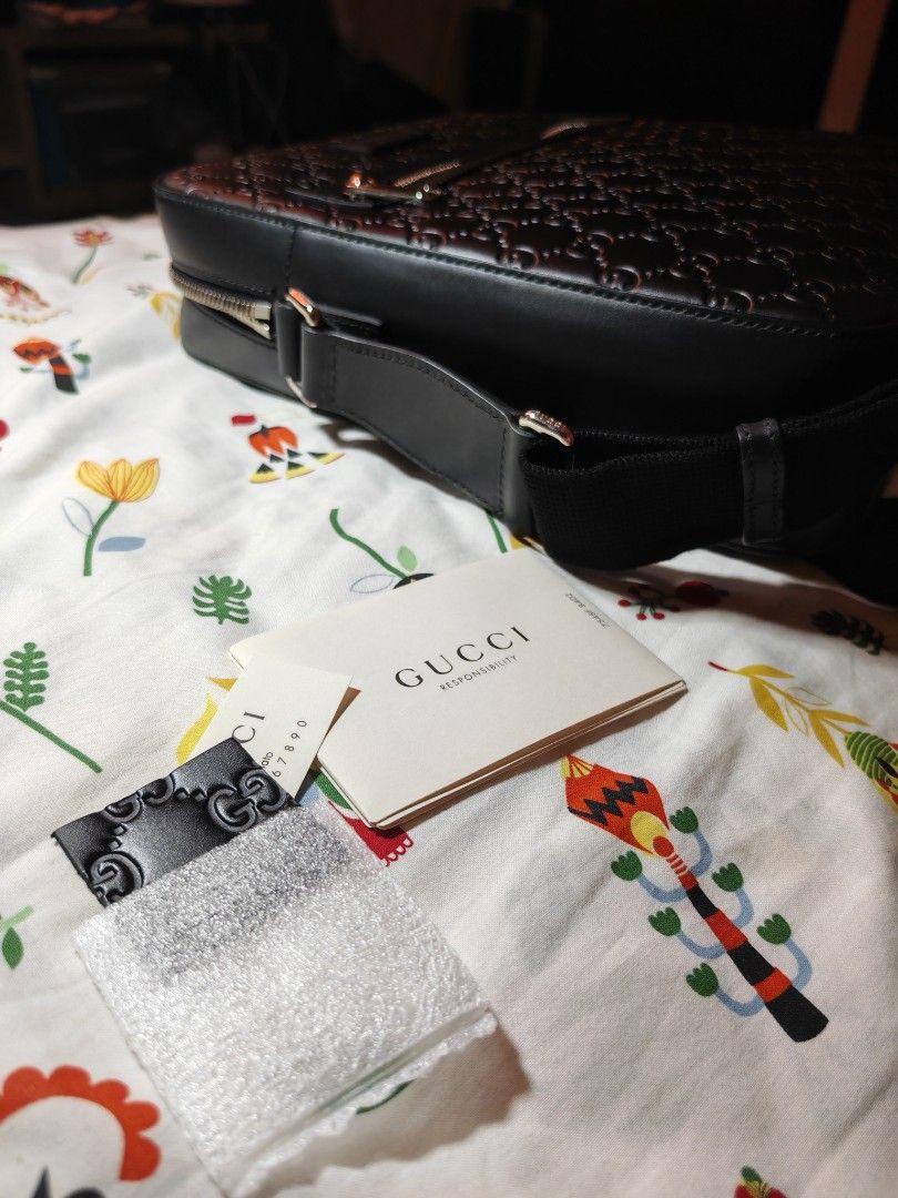 Gucci Black Leather GG Embossed Messenger Bag (Category: Luxury Bags & Wallets) located in Quezon City. Submitted by mike525 (Listing ID 1454933159, Image 2). Description: - Authentic black leather Gucci messenger bag - All-over GG embossed pattern - Zip closure on top - Front zip pocket - Interior small pouch Features a rectangular messenger silhouette with an adjustable strap for crossbody wear. - With Silver tone Hardware - Comes with authenti