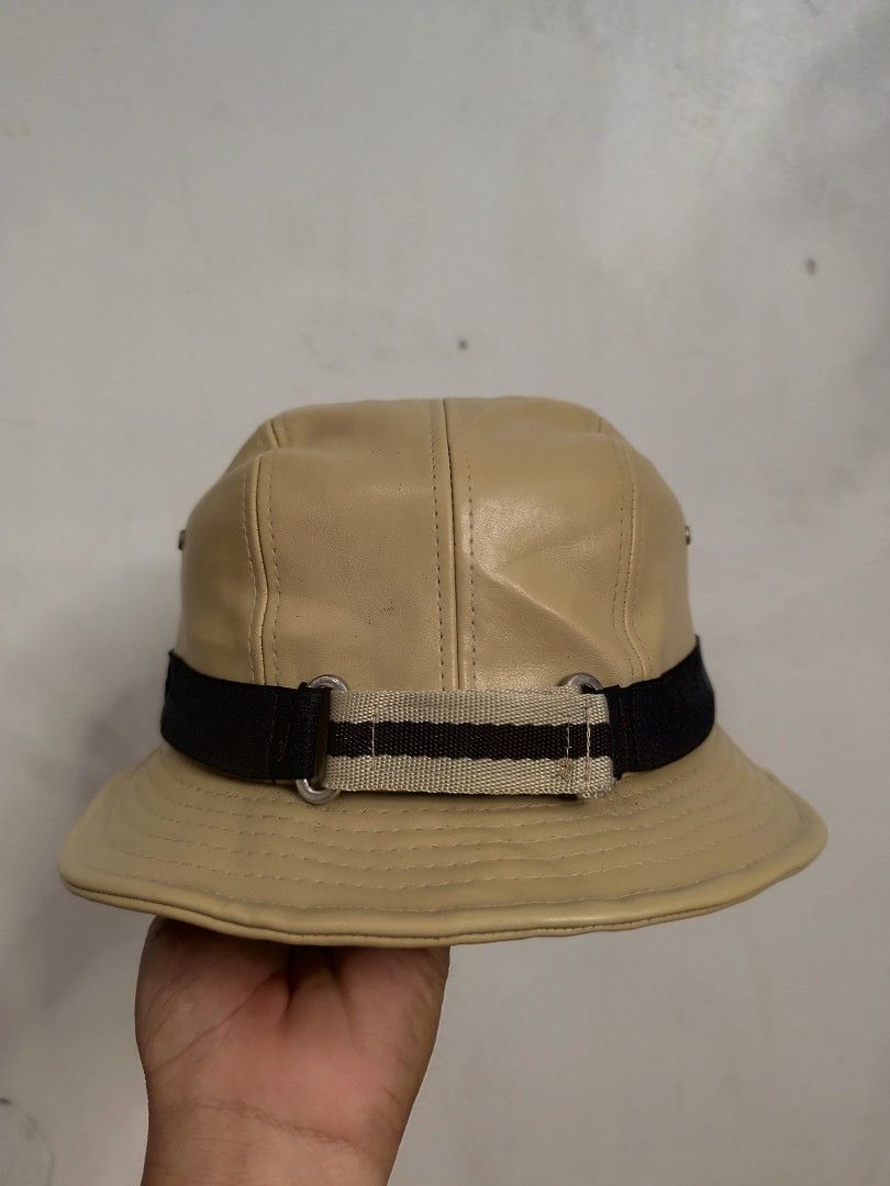 Gucci Bucket Hat Beige Leather (Category: Luxury Accessories) located in Cordova. Submitted by bsb.streetluxvintage.clothing (Listing ID 1454752864, Image 1). Description: - Authentic Gucci bucket hat - Beige leather material - Black and striped band detail - Made in Italy - Minor marks on interior - Perfect accessory for any outfit.