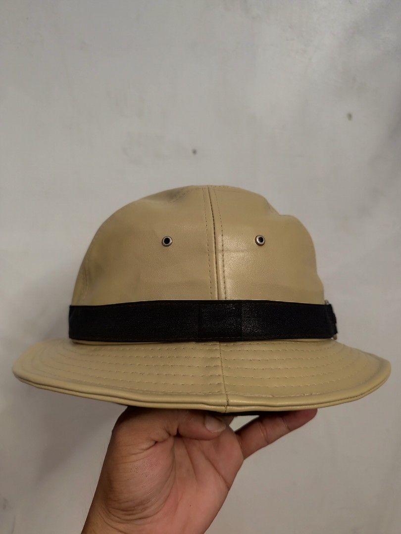 Gucci Bucket Hat Beige Leather (Category: Luxury Accessories) located in Cordova. Submitted by bsb.streetluxvintage.clothing (Listing ID 1454752864, Image 2). Description: - Authentic Gucci bucket hat - Beige leather material - Black and striped band detail - Made in Italy - Minor marks on interior - Perfect accessory for any outfit.