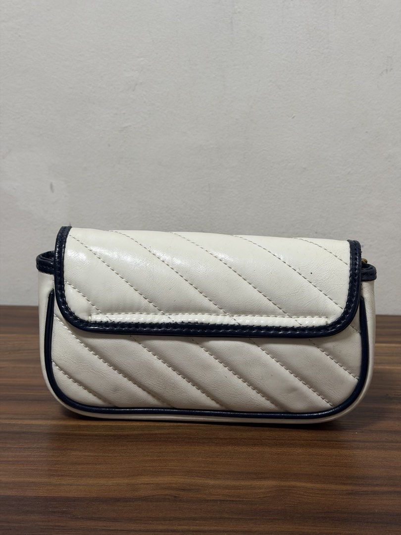 Gucci Leather Marmont Super Mini (Category: Luxury Bags & Wallets) located in Quezon City. Submitted by shop_mnl (Listing ID 1454895401, Image 3). Description: - Authentic White Gucci Marmont Bag - Quilted Leather with Navy Trim - Iconic Gold GG Logo Hardware - Versatile Chain Strap - Made in Italy - Exterior is clean and well-maintained - Ideal for nights out or everyday use.