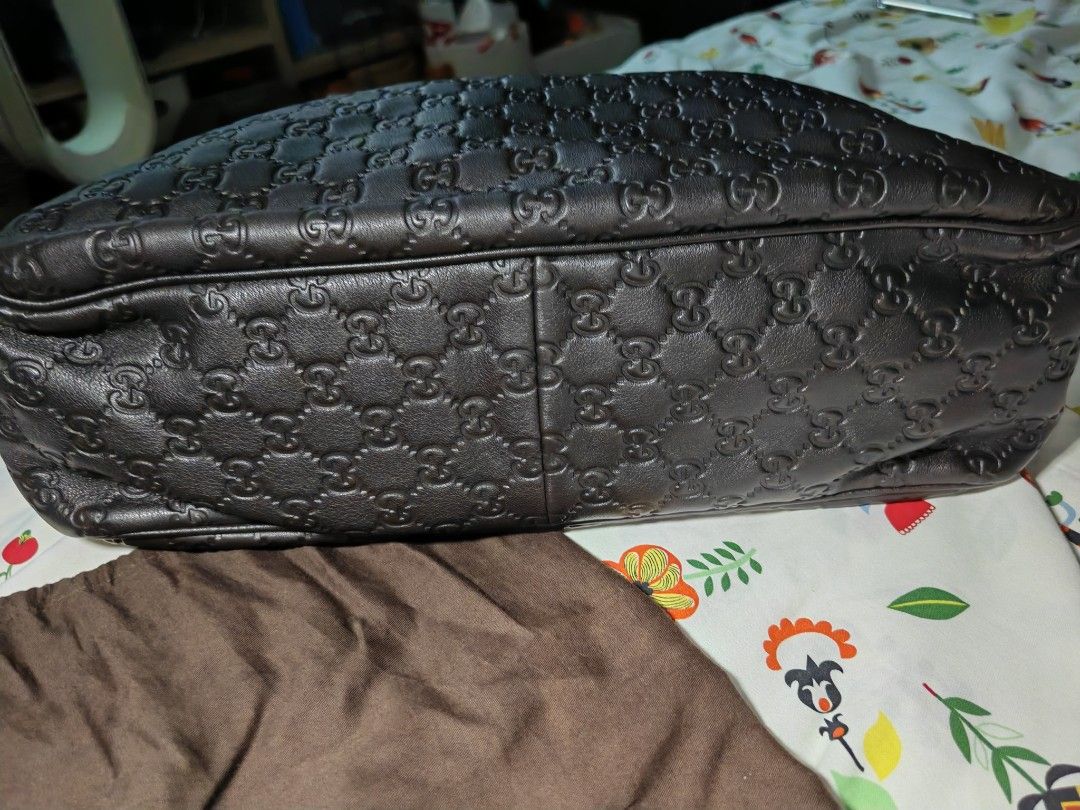 Gucci Monogram Leather Messenger Bag (Category: Luxury Bags & Wallets) located in Quezon City. Submitted by mike525 (Listing ID 1454934147, Image 3). Description: - Authentic Gucci messenger bag - Dark brown leather with embossed GG monogram - Spacious interior with internal zip pocket - Includes original dust bag - Ideal for daily use and travel.