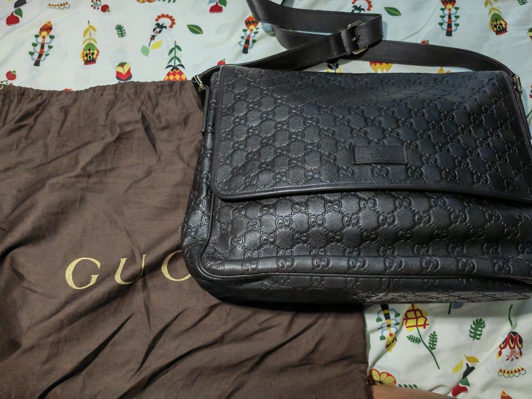Gucci Monogram Leather Messenger Bag (Category: Luxury Bags & Wallets) located in Quezon City. Submitted by mike525 (Listing ID 1454934147, Image 1). Description: - Authentic Gucci messenger bag - Dark brown leather with embossed GG monogram - Spacious interior with internal zip pocket - Includes original dust bag - Ideal for daily use and travel.