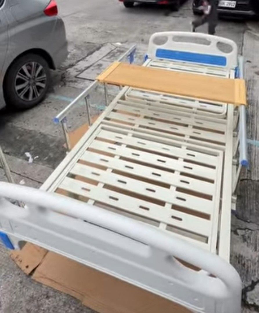 Hospital Bed Frame with Adjustable Headrest (Category: Bed Frames & Mattresses) located in Mandaluyong City. Submitted by quickmountain.780662 (Listing ID 1454807985, Image 1). Description: - Sturdy metal construction - Slatted base for support - Adjustable headrest with wooden panel - Safety side rails included - Ideal for home care needs - Easy assembly ✅ BRAND NEW PO ITO! NO MATRESS 2 CRANKS .