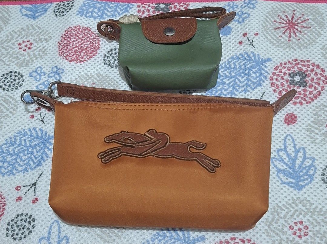 Longchamp Pouches - Green and Orange (Category: Purses & Pouches) located in Muntinlupa City. Submitted by abunching (Listing ID 1454928534, Image 1). Description: - Set of two Longchamp pouches (not original) - Small pouch: Green with brown leather snap closure and strap - Large pouch: Orange with signature embroidered horse logo - Both feature leather trim and zippers - Ideal for organizing small items and essentials.