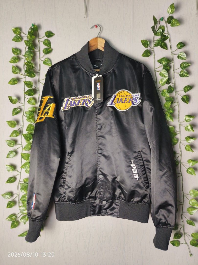 Los Angeles Lakers Satin Bomber Jacket (Category: Coats, Jackets and Outerwear) located in Baguio. Submitted by 01blaze (Listing ID 1454799565, Image 1). Description: BNEW PM sa details Meduim on pero large fitting - Black satin bomber jacket - Features Los Angeles Lakers graphics - Patches on the front - Large lettering on the back - Ribbed cuffs and hem - Button-up front - Ideal for Lakers fans.