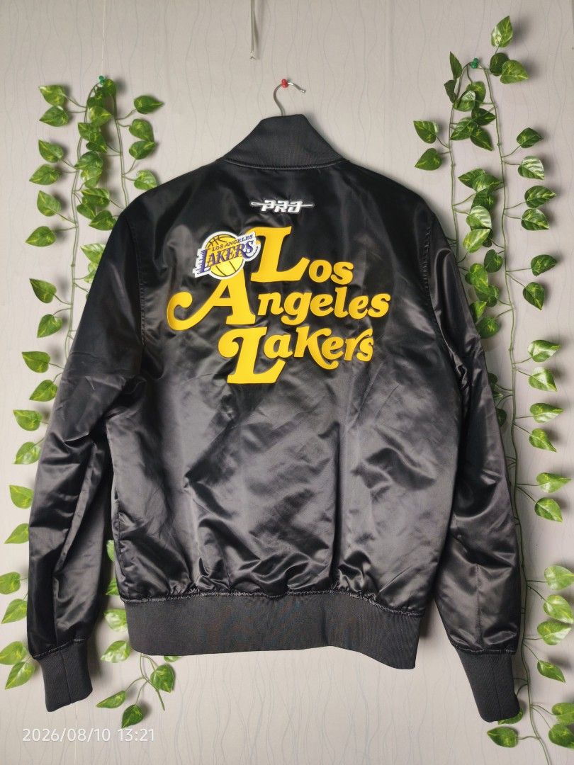 Los Angeles Lakers Satin Bomber Jacket (Category: Coats, Jackets and Outerwear) located in Baguio. Submitted by 01blaze (Listing ID 1454799565, Image 2). Description: BNEW PM sa details Meduim on pero large fitting - Black satin bomber jacket - Features Los Angeles Lakers graphics - Patches on the front - Large lettering on the back - Ribbed cuffs and hem - Button-up front - Ideal for Lakers fans.