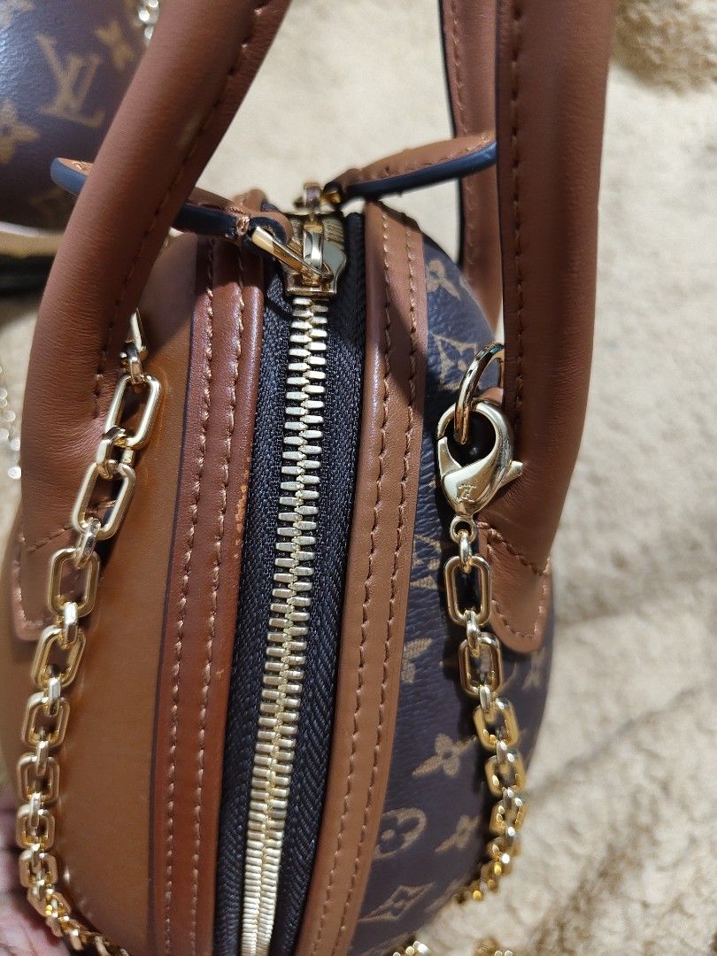Louis Vuitton Egg Shaped Handbag with Chain (Category: Luxury Bags & Wallets) located in Makati City. Submitted by tin_erwin (Listing ID 1454942810, Image 2). Description: - Unique egg-shaped handbag/sling - Monogram canvas with brown leather trim - Includes gold chain strap - Secure zipper closure - Lined with leather interior - Excellent statement accessory -Buy one get One. The black one is already oxidizing -negotiable.