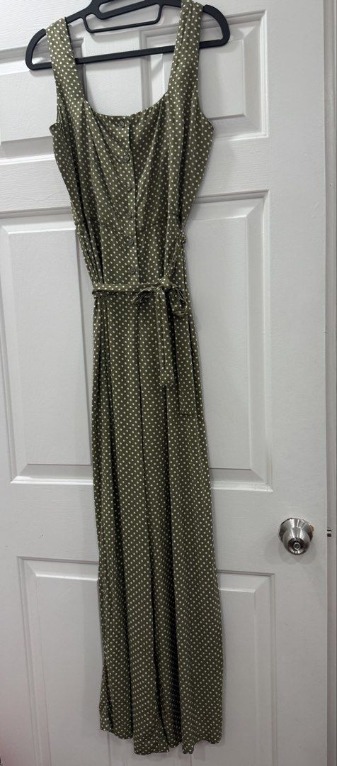 Mango Polka Dot Jumpsuit Olive Green Size XS (Category: Jumpsuits) located in Pasig City. Submitted by atbp__ (Listing ID 1454879135, Image 2). Description: - Olive green jumpsuit with white polka dots - Flattering square neckline - Functional button-down front - Includes a tie belt to cinch the waist - Stylish wide leg pants - Versatile for casual outings or evening events - Combines comfort and style.