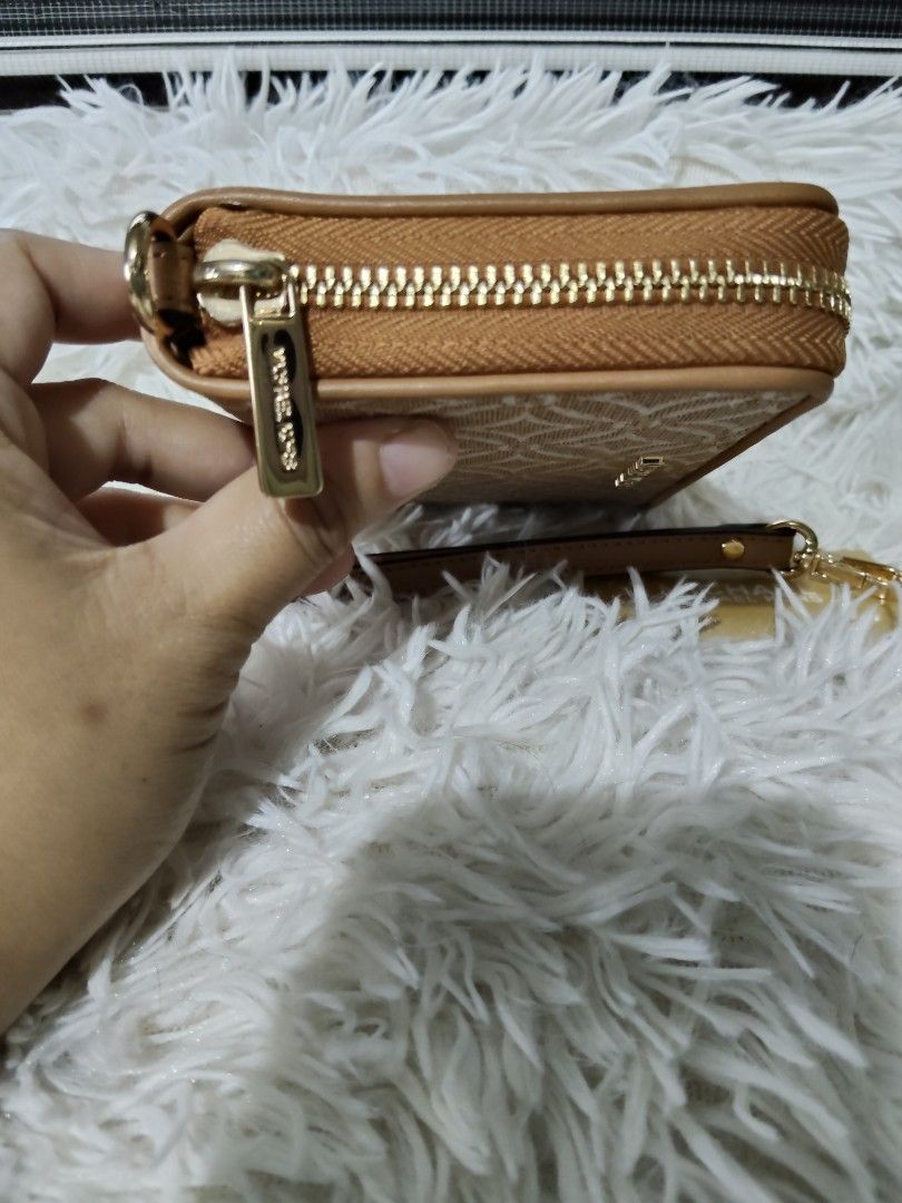 Michael Kors Zip Around Wallet (Category: Luxury Bags & Wallets) located in Iba. Submitted by royalgemini (Listing ID 1453477874, Image 2). Description: - Authentic Michael Kors zip-around wallet - Classic tan and white MK pattern - Comes with a detachable wrist strap - Plenty of space for cards and cash - Includes authenticity card.