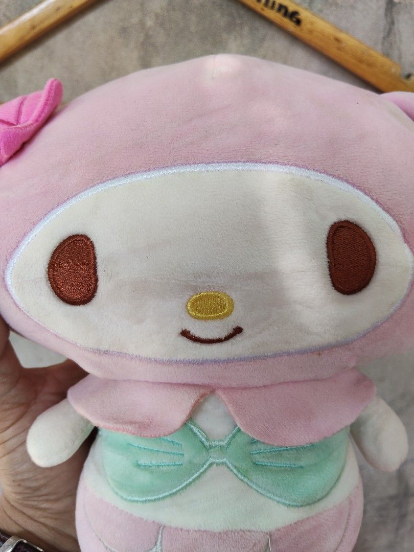 My Melody Mermaid Plush Toy (Category: Plushies & Soft Toys) located in City of Isabela. Submitted by jasheverything (Listing ID 1454918366, Image 3). Description: - Adorable My Melody plush toy dressed as a mermaid. - Features a cute pink design with a mint green bikini top and tail. - Ideal for Sanrio enthusiasts and collectors. - Perfect for decorating your space or for cozy cuddles. - A charming addition to any Sanrio collection. Very Good Co