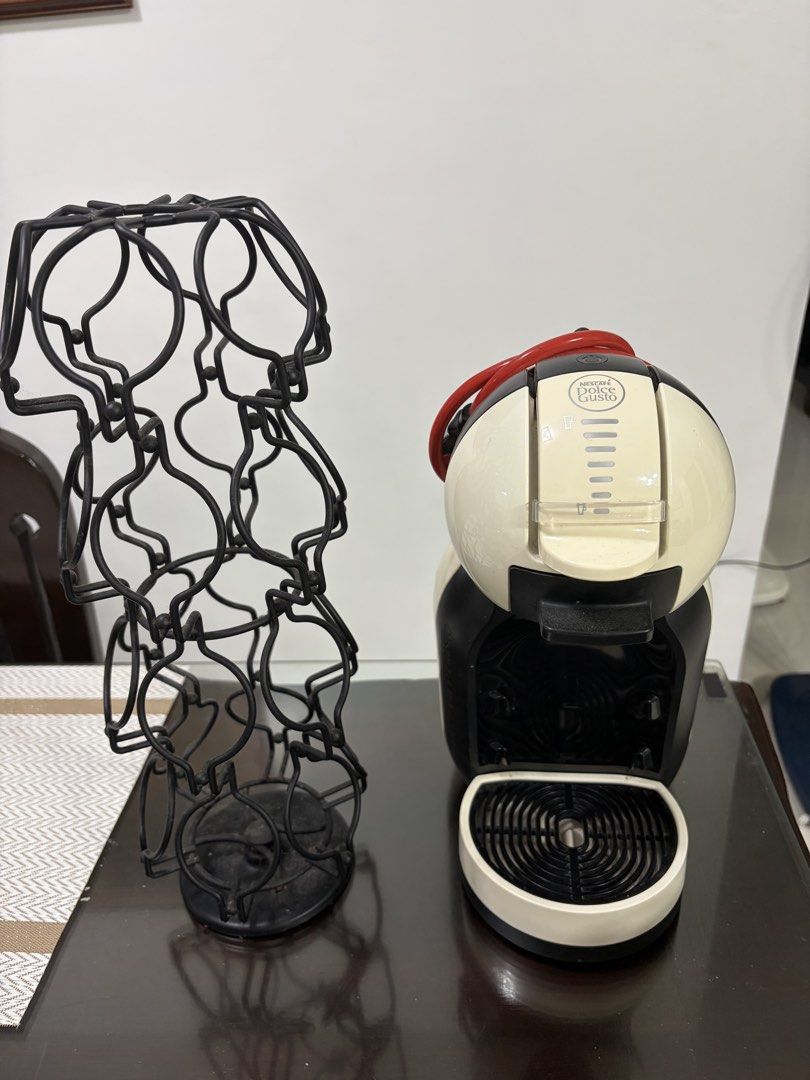 Nescafé Dolce Gusto Mini Me Coffee Machine + Capsule Holder (Category: Coffee Machines & Makers) located in Manila. Submitted by kaith006 (Listing ID 1454837494, Image 1). Description: Pre-loved and still in good working condition. Comes with the capsule/pod holder shown in the photo. ☕️ Perfect for quick and easy coffee at home. Selling as a set..