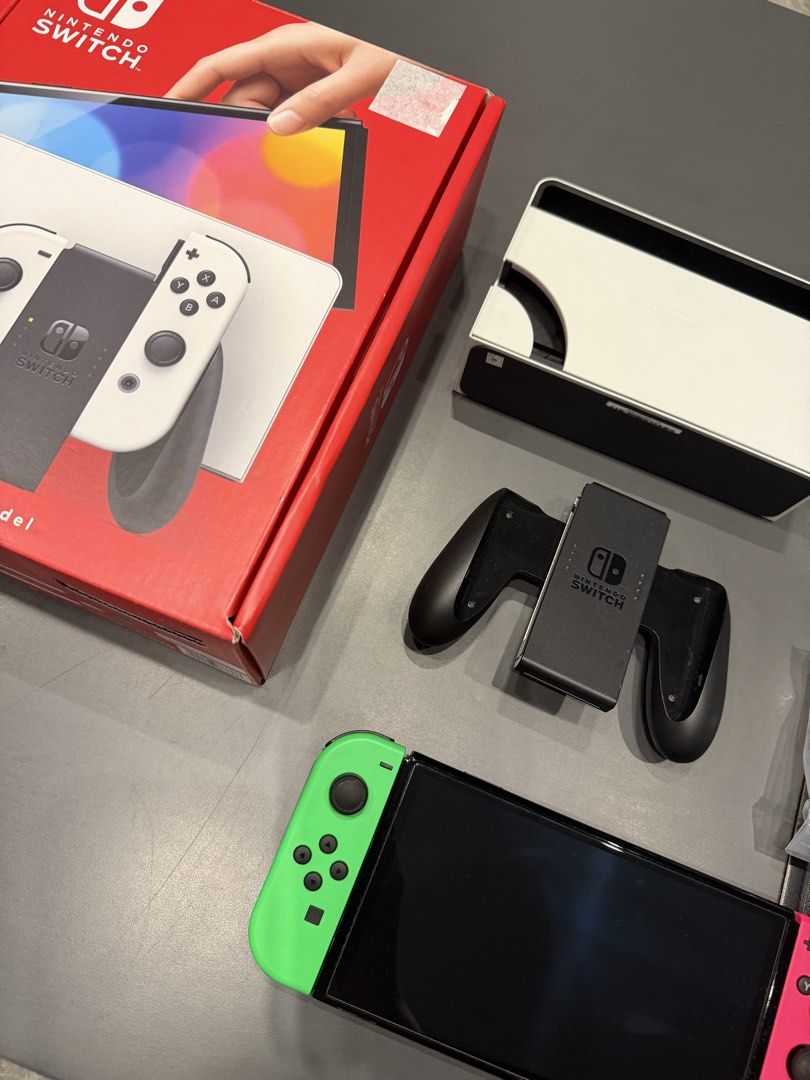 Nintendo Switch OLED Model (Category: Nintendo) located in Manila. Submitted by 17thfinds (Listing ID 1454909721, Image 3). Description: - Nintendo Switch OLED Model - Includes: Console, Dock, Neon Green & Pink Joy-Cons, Joy-Con Grip, AC Adapter, HDMI Cable - All original packaging and manuals included - used around a year and during summer vacation only. FYI - All Accessories are new never used except for the charger - Installed screen protector