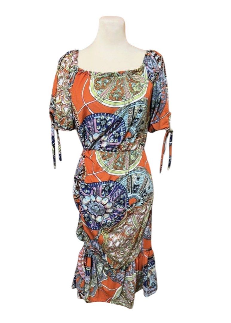 Orange Boho Print Square Neck Ruched Midi Dress (Category: Dresses) located in Quezon City. Submitted by letsdeclutter101 (Listing ID 1454914663, Image 2). Description: - Vibrant orange midi dress with a boho print - Features a flattering square neckline - Side ruching for a customized fit - Sleeves with cute tie details - Flowy ruffled hemline - Ideal for casual wear or your next vacation.