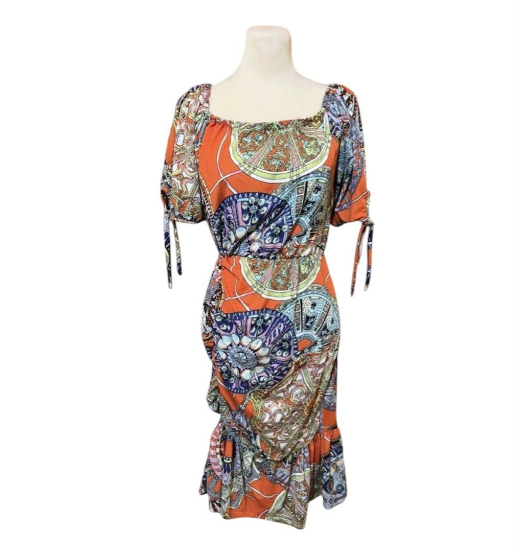 Orange Boho Print Square Neck Ruched Midi Dress (Category: Dresses) located in Quezon City. Submitted by letsdeclutter101 (Listing ID 1454914663, Image 1). Description: - Vibrant orange midi dress with a boho print - Features a flattering square neckline - Side ruching for a customized fit - Sleeves with cute tie details - Flowy ruffled hemline - Ideal for casual wear or your next vacation.