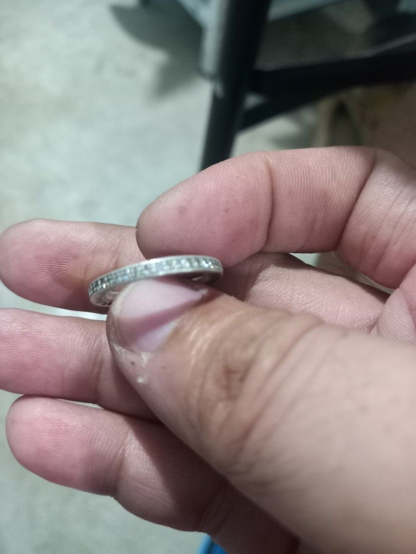 Pandora Silver Ring with Hearts and Stones (Category: Rings) located in Subic. Submitted by regiegabriel29 (Listing ID 1454782831, Image 3). Description: - Genuine sterling silver ring - Delicate pattern of small hearts encircling the band - Accented with small, sparkling stones - Estimated size 52 - Versatile for stacking with other rings or as a standalone piece.