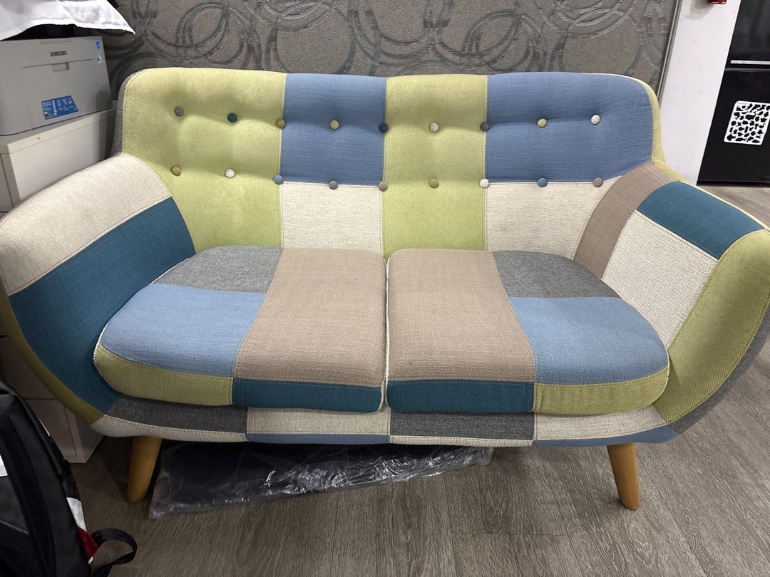 Patchwork Two-Seater Sofa (Category: Sofas) located in Singapore. Submitted by foojq (Listing ID 1454905891, Image 1). Description: - Unique two-seater sofa - Unique patchwork design with blue, green, beige, and grey fabrics - Button tufted backrest for added detail - Sturdy wooden legs - Adds a vibrant pop of color to any room - Ideal for small apartments or cozy corners - Self collect only.