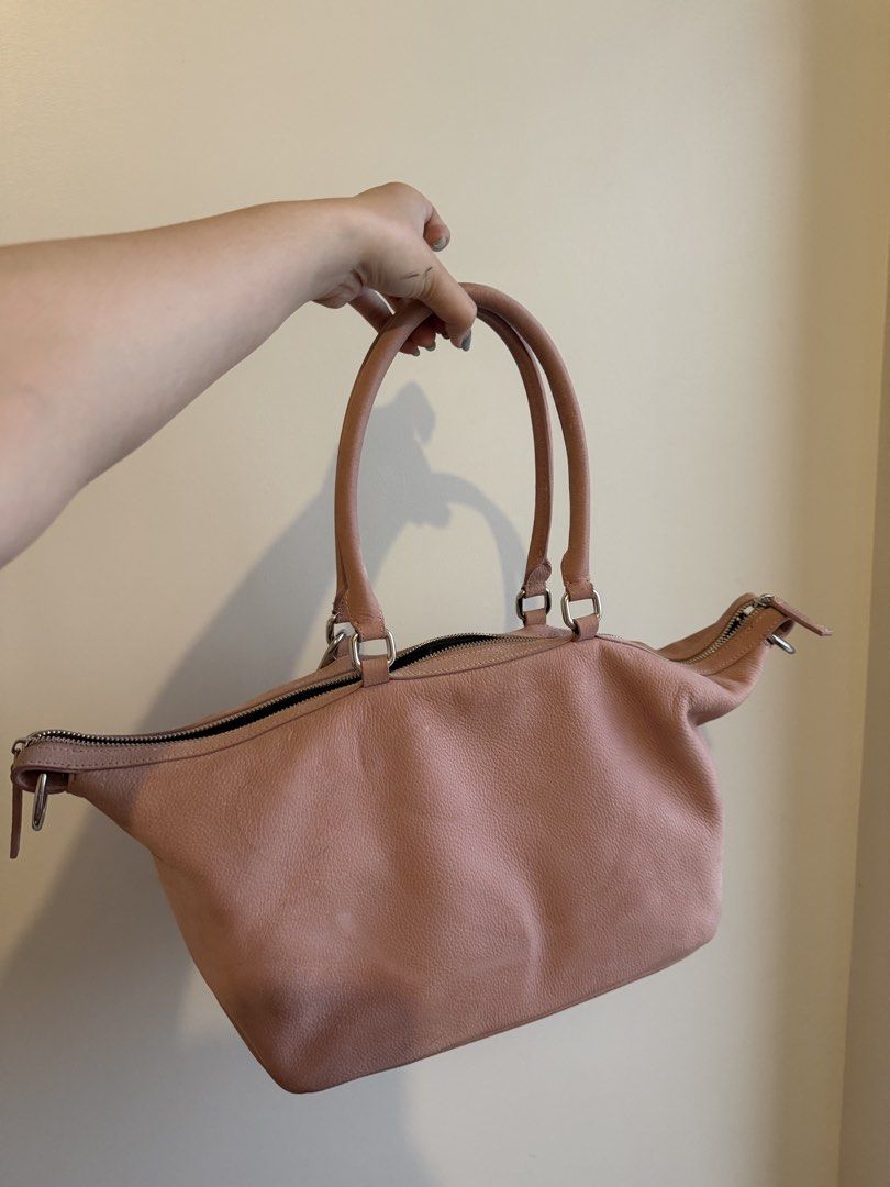 Pink Leather Handbag with Charm (Category: Luxury Bags & Wallets) located in Manila. Submitted by namisxan (Listing ID 1454853705, Image 2). Description: - Marge Sherwood inspired - no sling - pink suede fabric - Cute pink leather handbag - Zip closure and two top handles - Comes with a little charm - Plenty of space inside - Great for everyday use - Shows some minor signs of wear but still in good shape.