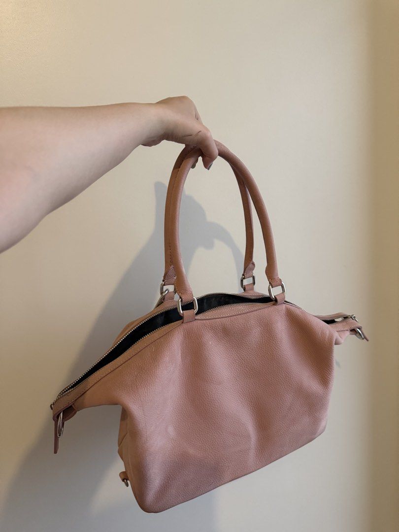 Pink Leather Handbag with Charm (Category: Luxury Bags & Wallets) located in Manila. Submitted by namisxan (Listing ID 1454853705, Image 3). Description: - Marge Sherwood inspired - no sling - pink suede fabric - Cute pink leather handbag - Zip closure and two top handles - Comes with a little charm - Plenty of space inside - Great for everyday use - Shows some minor signs of wear but still in good shape.