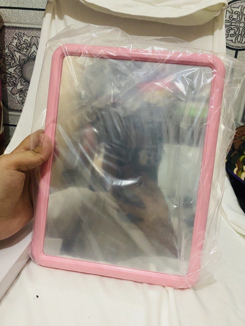 Pink Table Mirror (Category: Mirrors) located in Taguig. Submitted by chlia22 (Listing ID 1454882138, Image 1). Description: ✨ Pink frame ✨ Standing/free-standing design ✨ Can be tilted/adjusted for viewing ✨ Simple and cute aesthetic ✨ Price is NEGOTIABLE ✨ Great for makeup, hair, and OOTD checks Condition: Good pre-loved condition. May have minor signs of use/storage. Please check the photos for the actual condition..