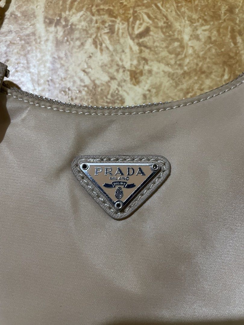 Prada Nylon Shoulder Bag (Category: Luxury Bags & Wallets) located in Iligan City. Submitted by yolkfinds (Listing ID 1454929446, Image 2). Description: - Authentic Prada shoulder bag - Beige nylon material - Silver chain strap - Classic Prada triangle logo on front - Zipper closure - Interior Prada Milano tag - Ideal for everyday use.