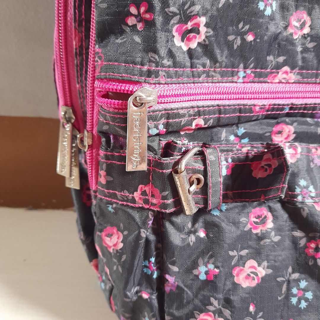 Pre-loved Heartstrings Floral Backpack (Black & Pink) (Category: Backpacks) located in Dasmarinas. Submitted by pb_declutters (Listing ID 1454777464, Image 3). Description: Selling this authentic, stylish, and highly practical Heartstrings backpack. Perfect for school, casual travel, or daily commuting! Product Details: • Brand: Heartstrings (Local Brand) • Pattern: All-over mini pink and red floral print on a black background • Accent Colors: Vi