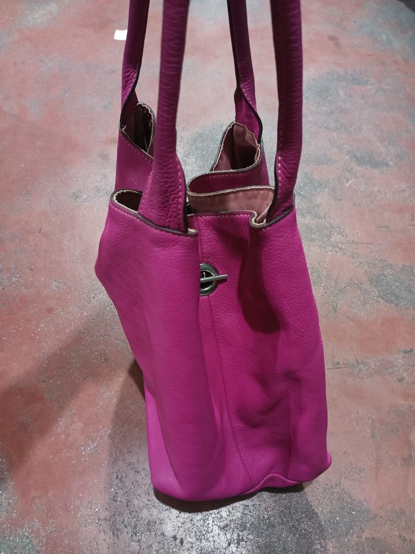 Rabeanco Pink Leather Tote Bag (Category: Luxury Bags & Wallets) located in Quezon City. Submitted by arvietekto (Listing ID 1454932283, Image 2). Description: Rabeanco Genuine Leather Tote bag excellent quality excellent materials affordable just message me for additional information and deals. - Stylish pink leather tote bag - Elegant silver hardware detail on the front - Contrasting purple fabric interior - Includes a convenient zippered pocke
